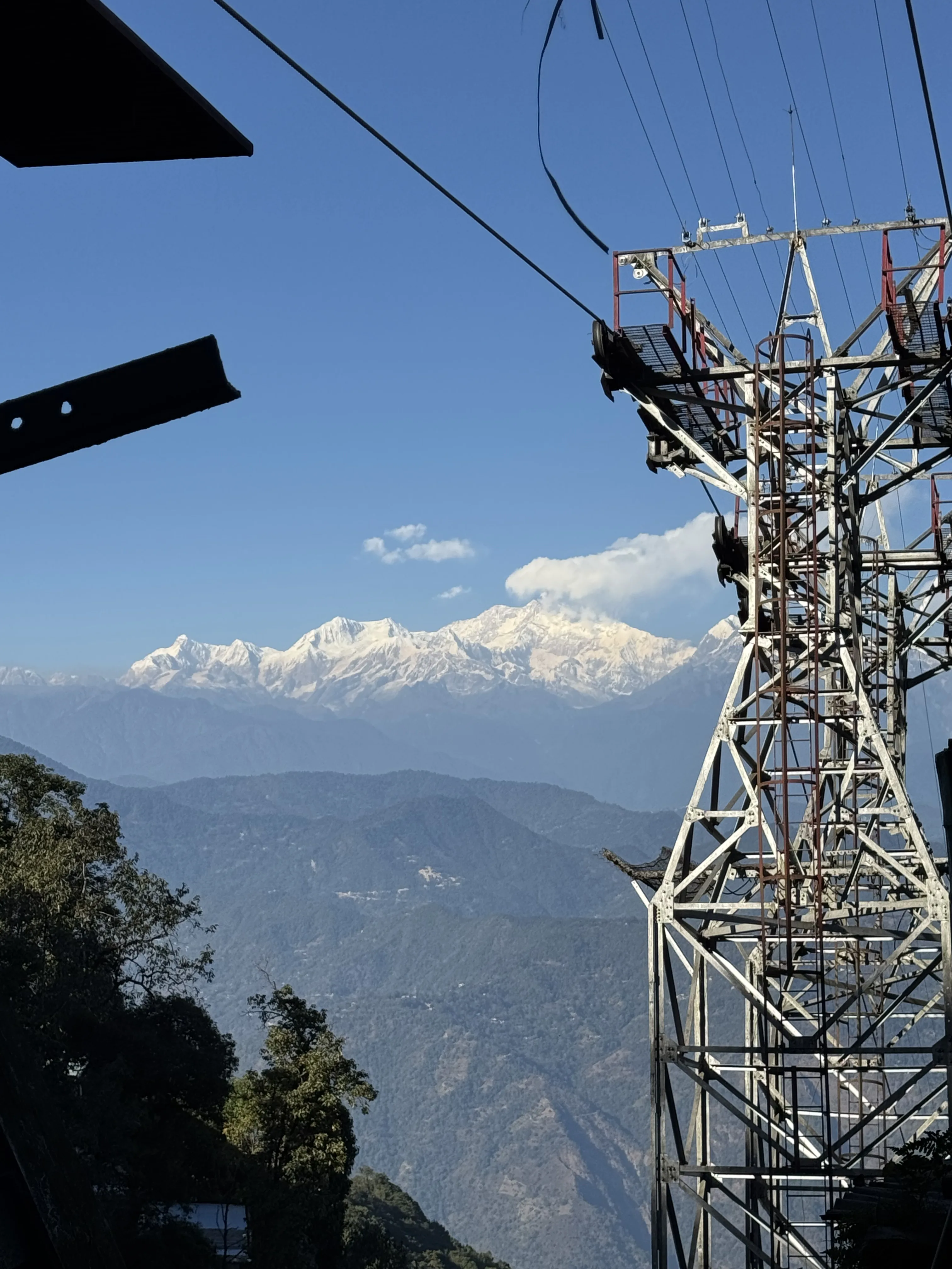 Darjeeling Ropeway cutting across the hills with Kanchenjunga in the background